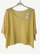 Yellow sweater on a hanger with a v neck