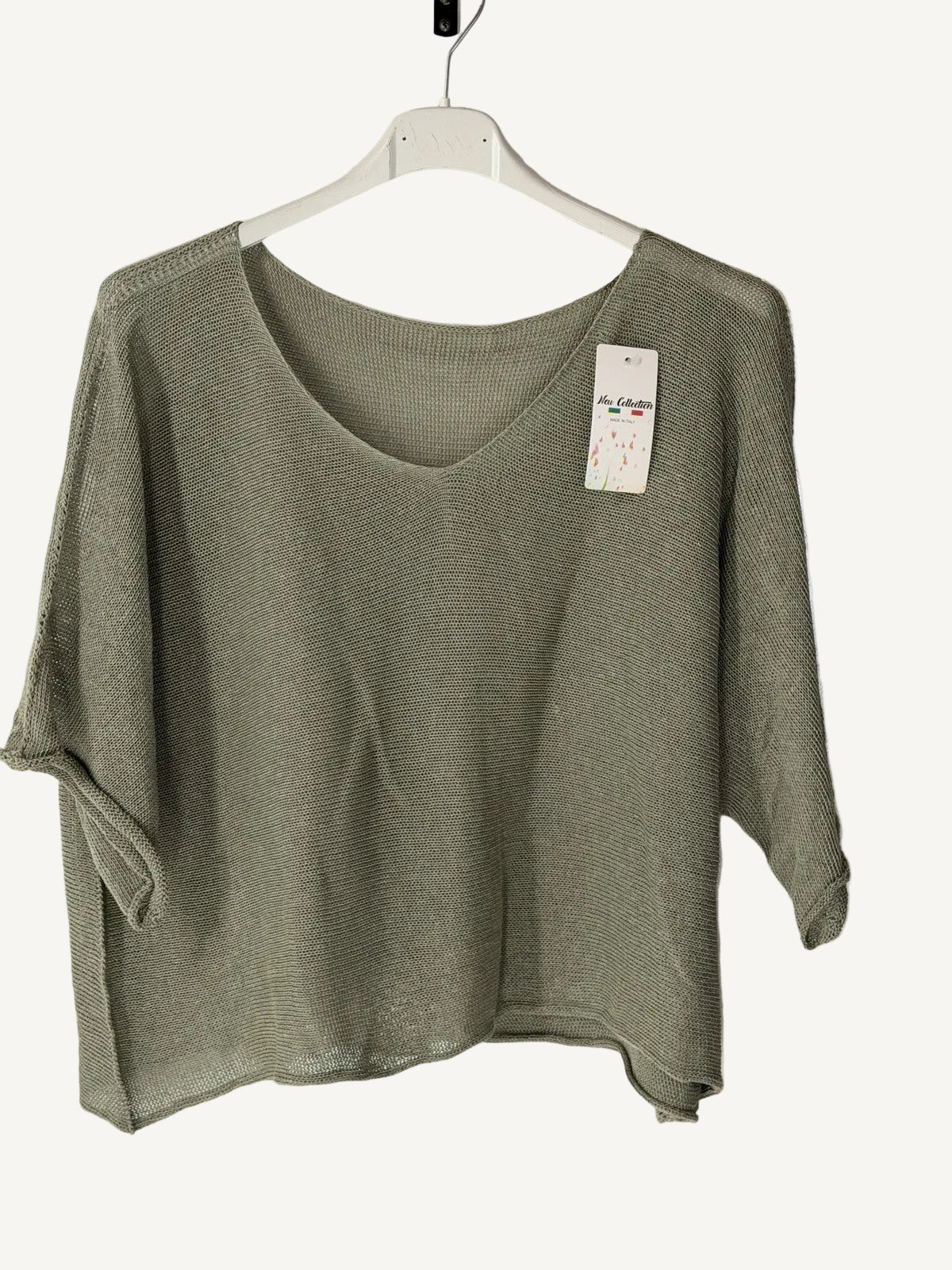 Green sweater on a hanger with 
v neck