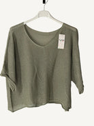 Green sweater on a hanger with 
v neck