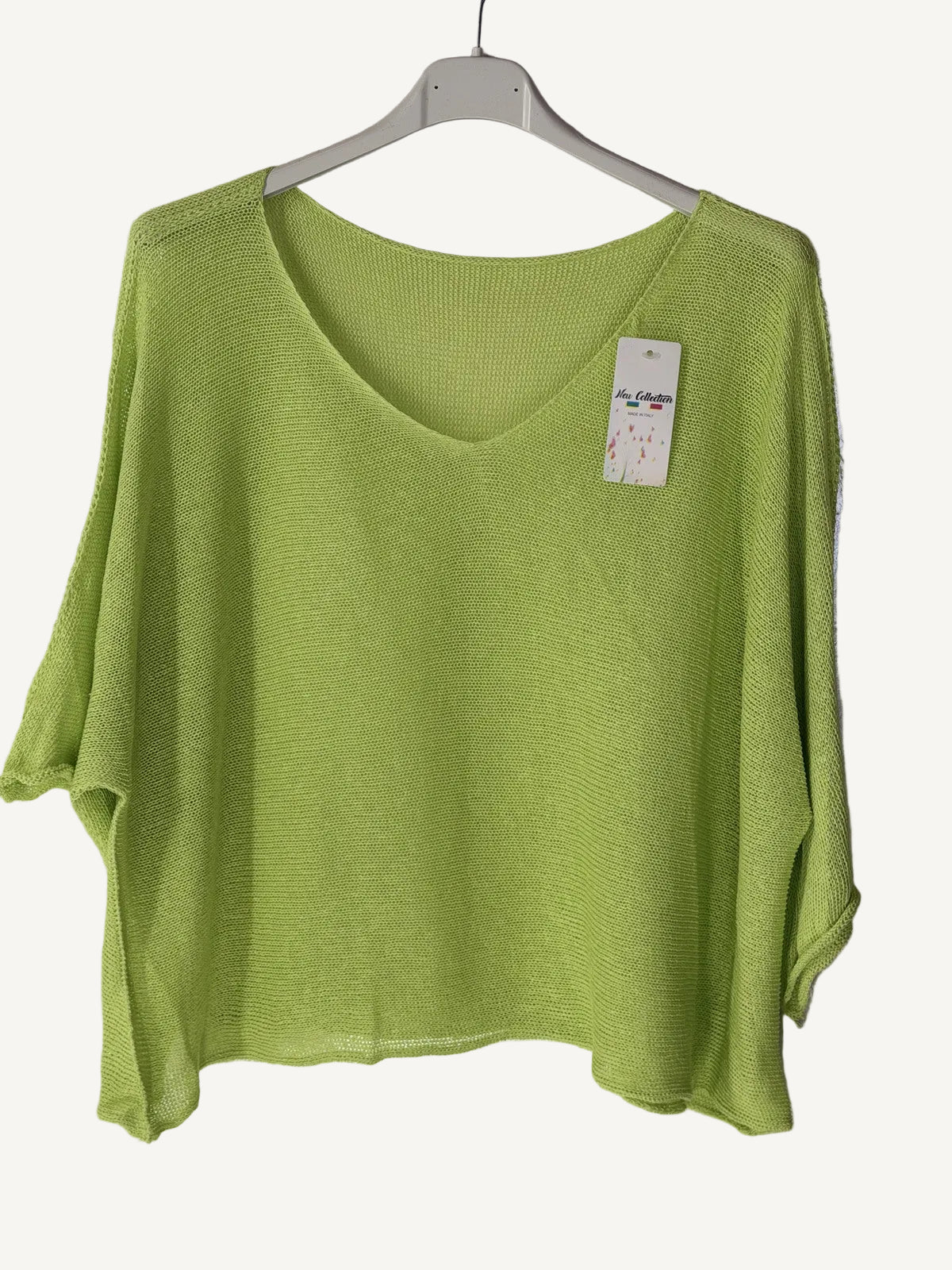 Green sweater with a v neck on a hanger 