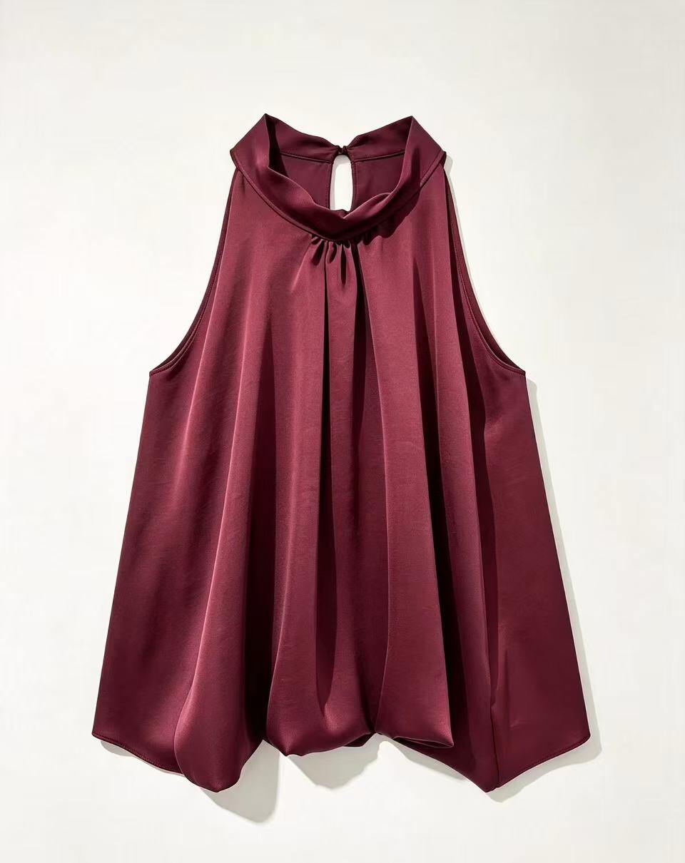 A sleeveless, high-neck top in a deep burgundy satin fabric, displayed flat against a light off-white background.