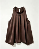 A sleeveless dark brown top with a draped, high-neck collar and a gathered front, displayed against a plain off-white background.