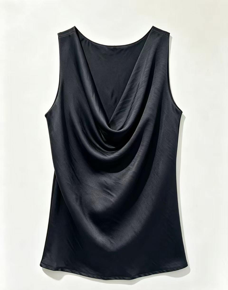 A sleeveless black cowl neck top with a draped, gathered silhouette, displayed flat against a light off-white background.