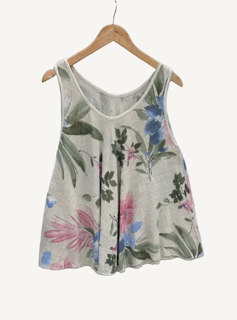 Floral-patterned sleeveless top on a hanger against a textured white background