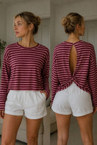 A woman modeling a long-sleeve striped top with a twist back opening, shown in front and back views.