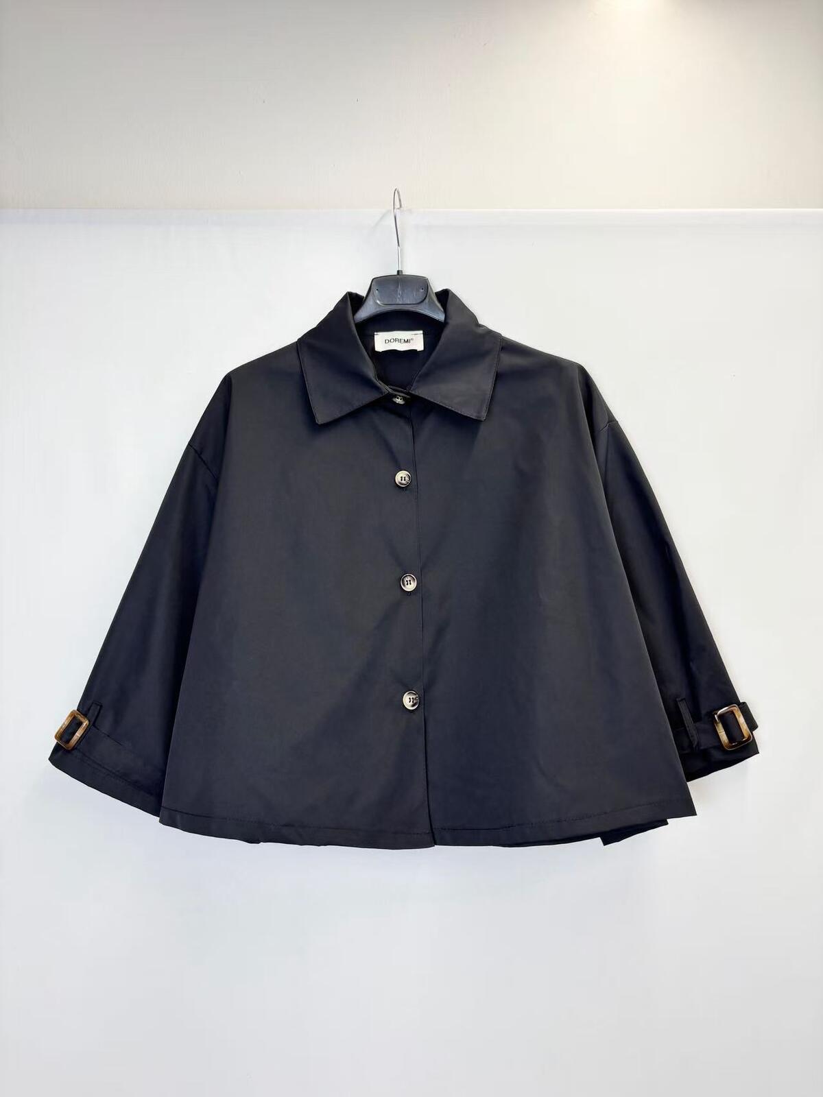 A black cropped long-sleeve collared jacket with button-front closure and adjustable cuff straps, 
