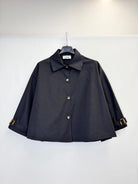 A black cropped long-sleeve collared jacket with button-front closure and adjustable cuff straps, 