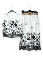 White top and skirt set with black floral patterns on hangers against a white background