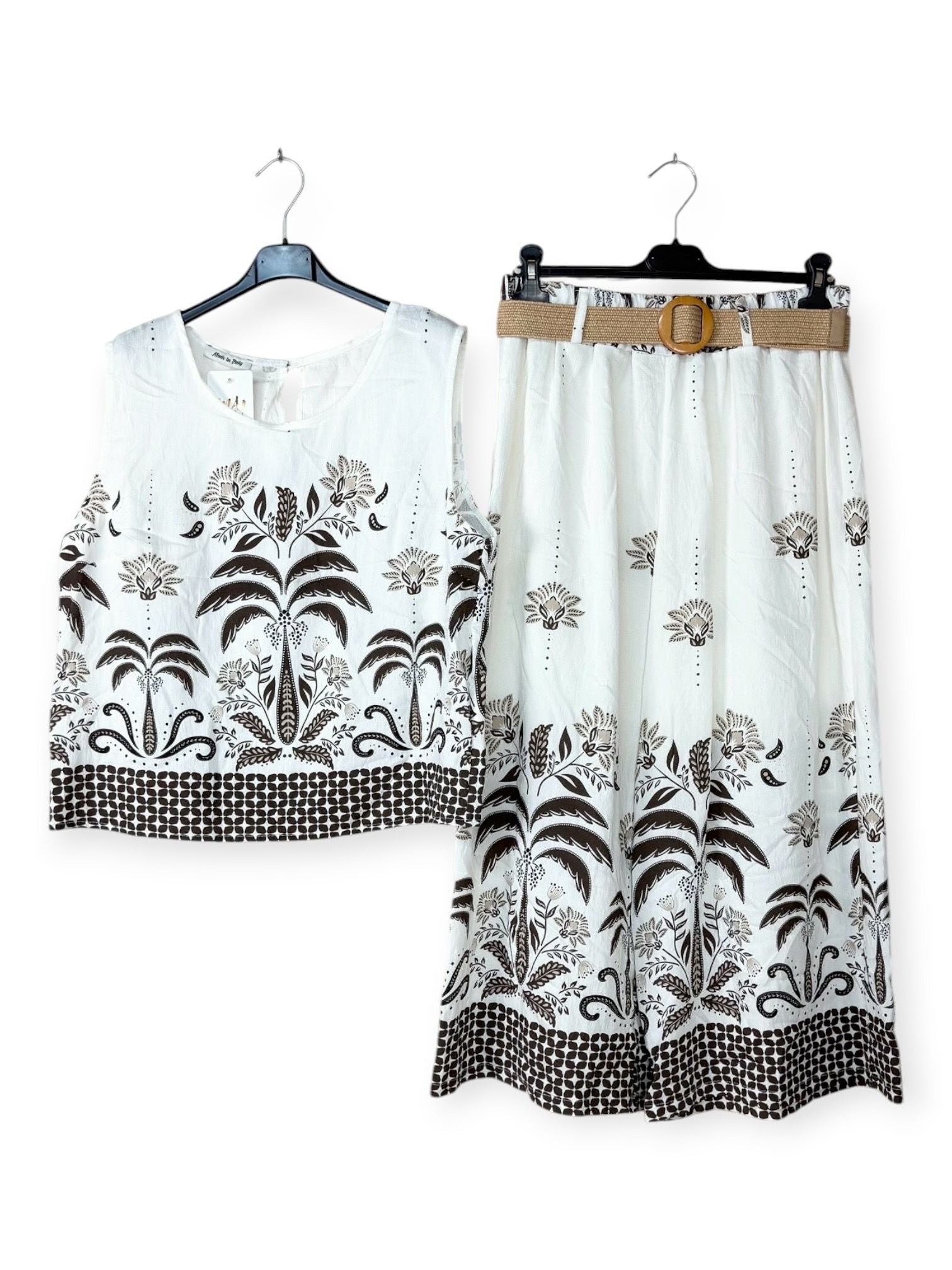 White outfit with brown floral patterns on a white background