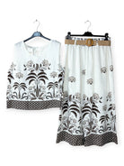 White outfit with brown floral patterns on a white background