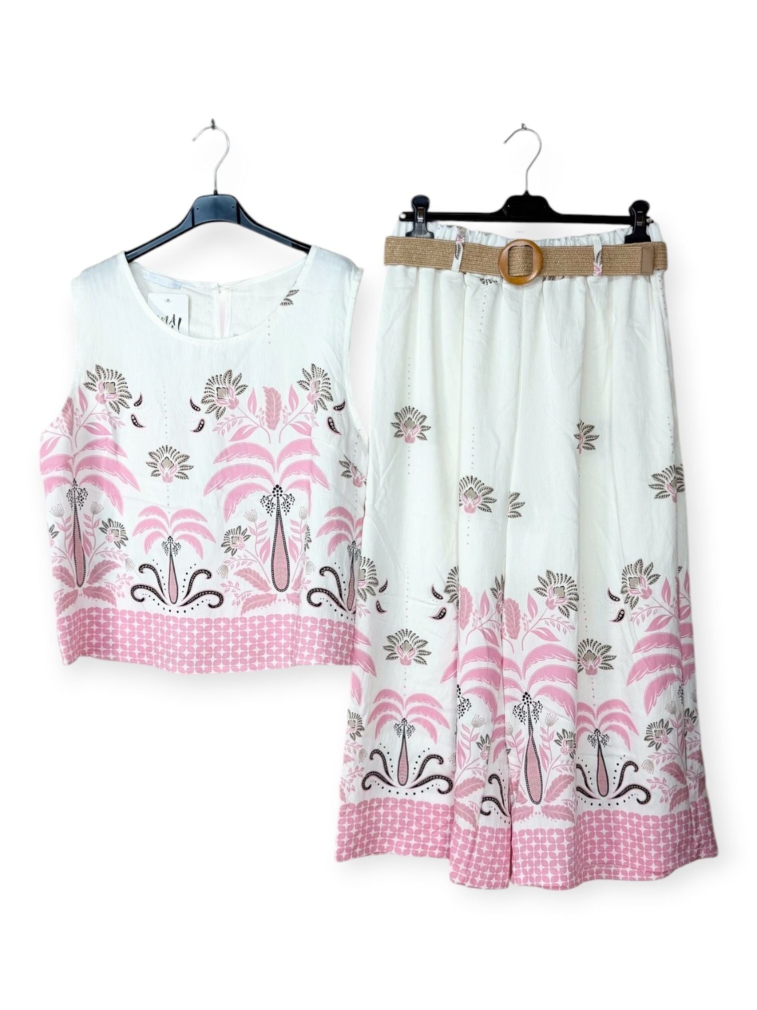 White outfit with pink floral patterns on a white background
