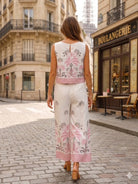 Woman in a floral two piece walking on a street with the Eiffel Tower in the background