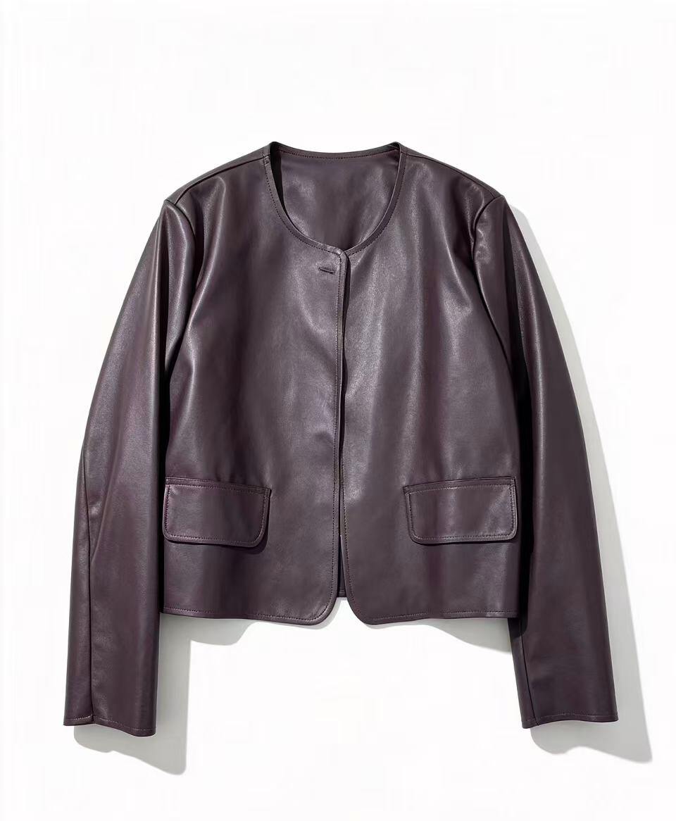 A cropped, long-sleeve leather jacket in a deep plum purple color, featuring a round neckline,  two front flap pocket
