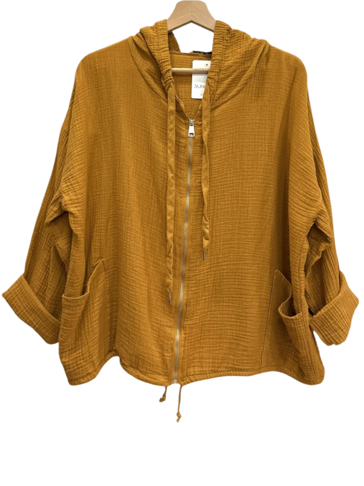 Mustard yellow hooded jacket on a hanger against a white wall.