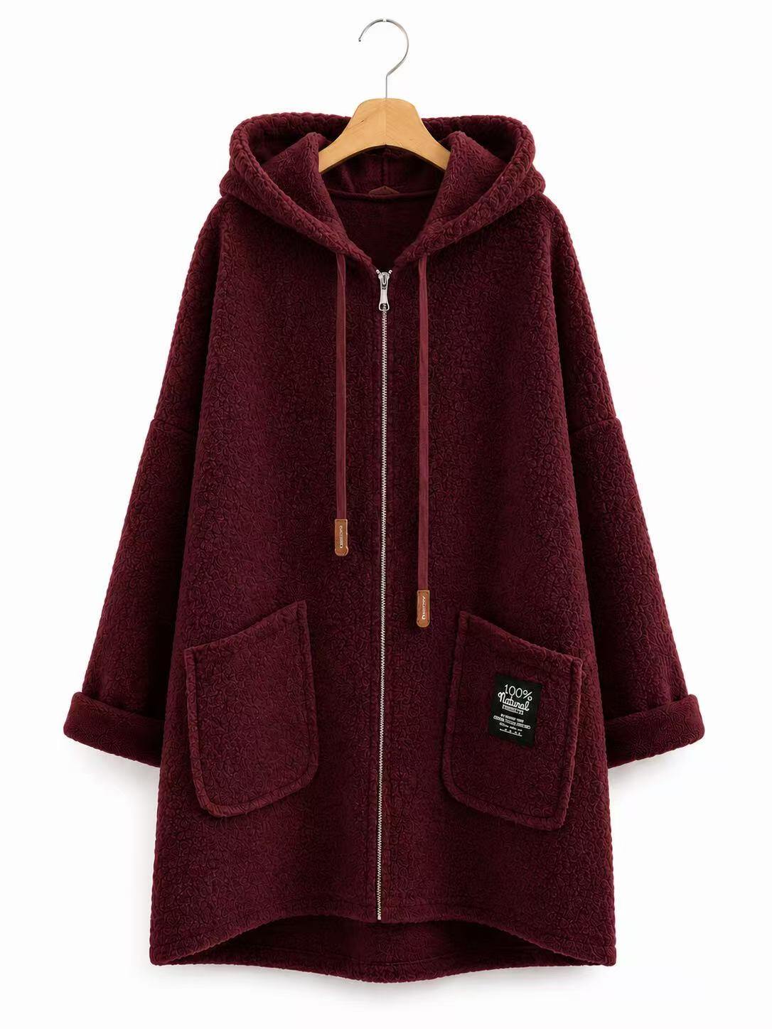 A burgundy sherpa fleece zip-up hoodie with a hood, drawstrings, and front pockets, hanging on a wooden hanger against a white background.