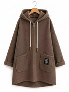 A brown fuzzy zip-up hooded jacket with white drawstrings, displayed on a wooden hanger against a plain white background.
