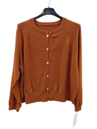 A rust-orange knit cardigan sweater with a crew neck and button closure, hanging on a black hanger