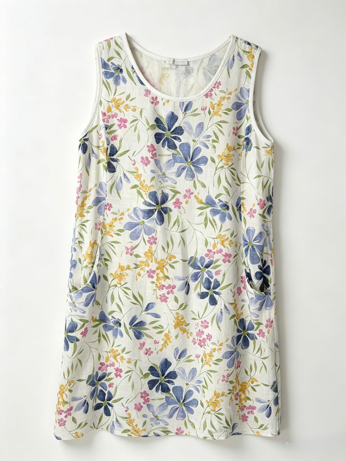A sleeveless white dress with a colourful watercolor floral print 