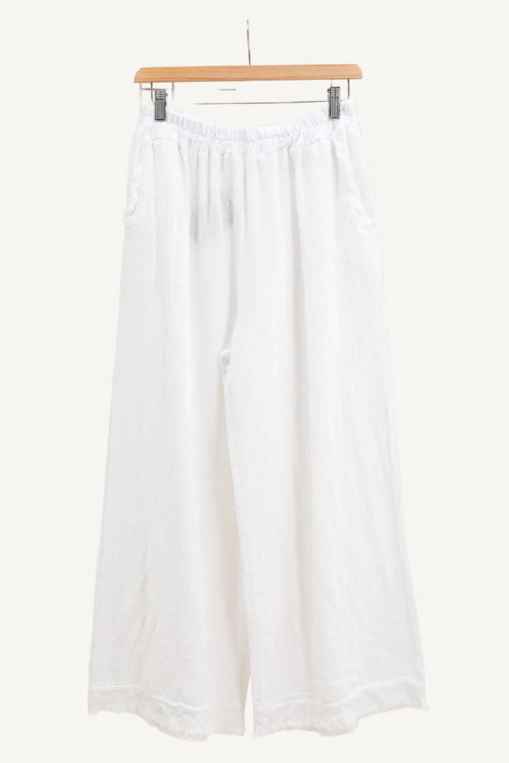 White wide-leg pants on a hanger against a white background