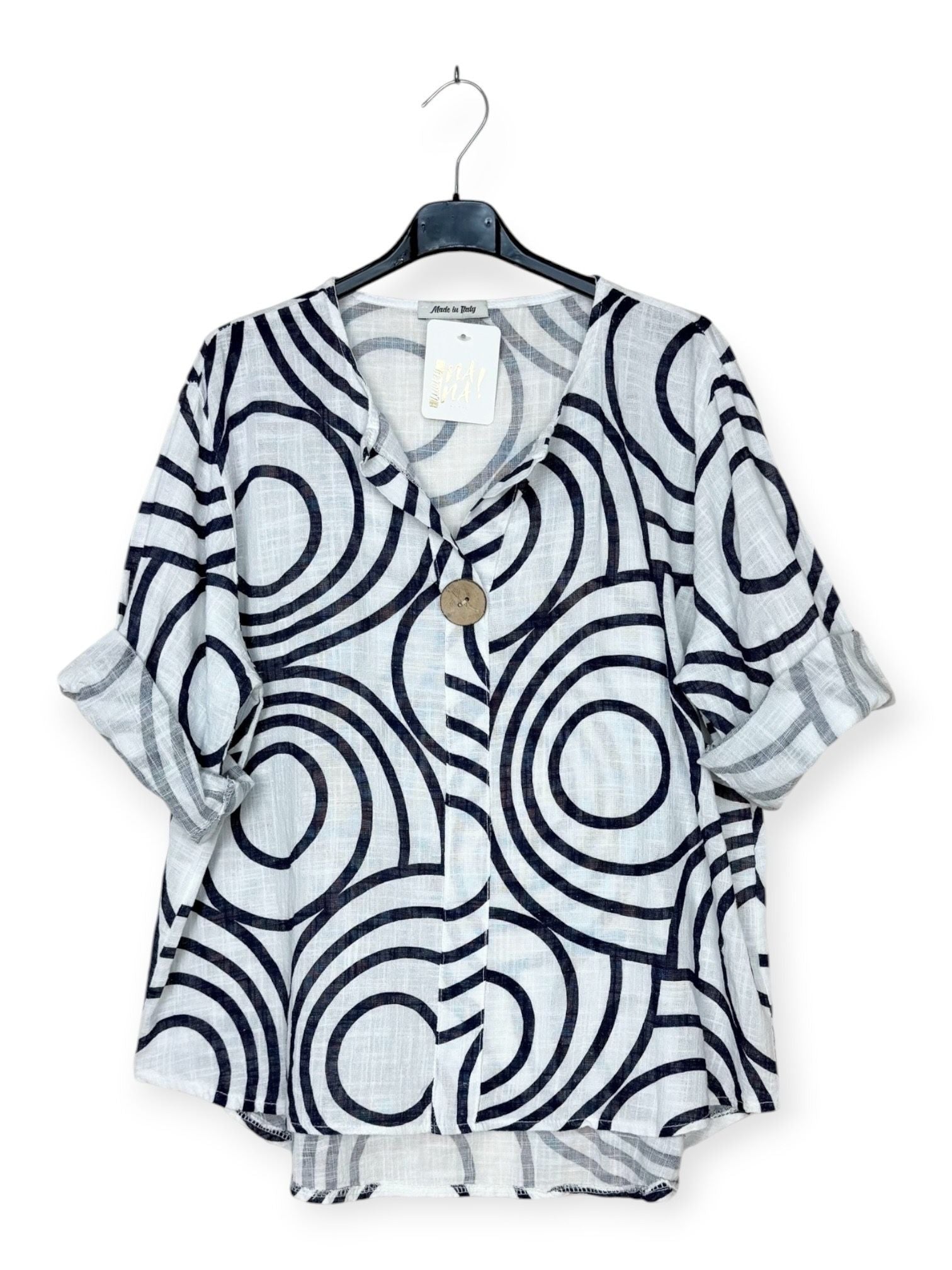 Black and white patterned shirt on a hanger with a white background