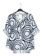 Black and white patterned shirt on a hanger with a white background