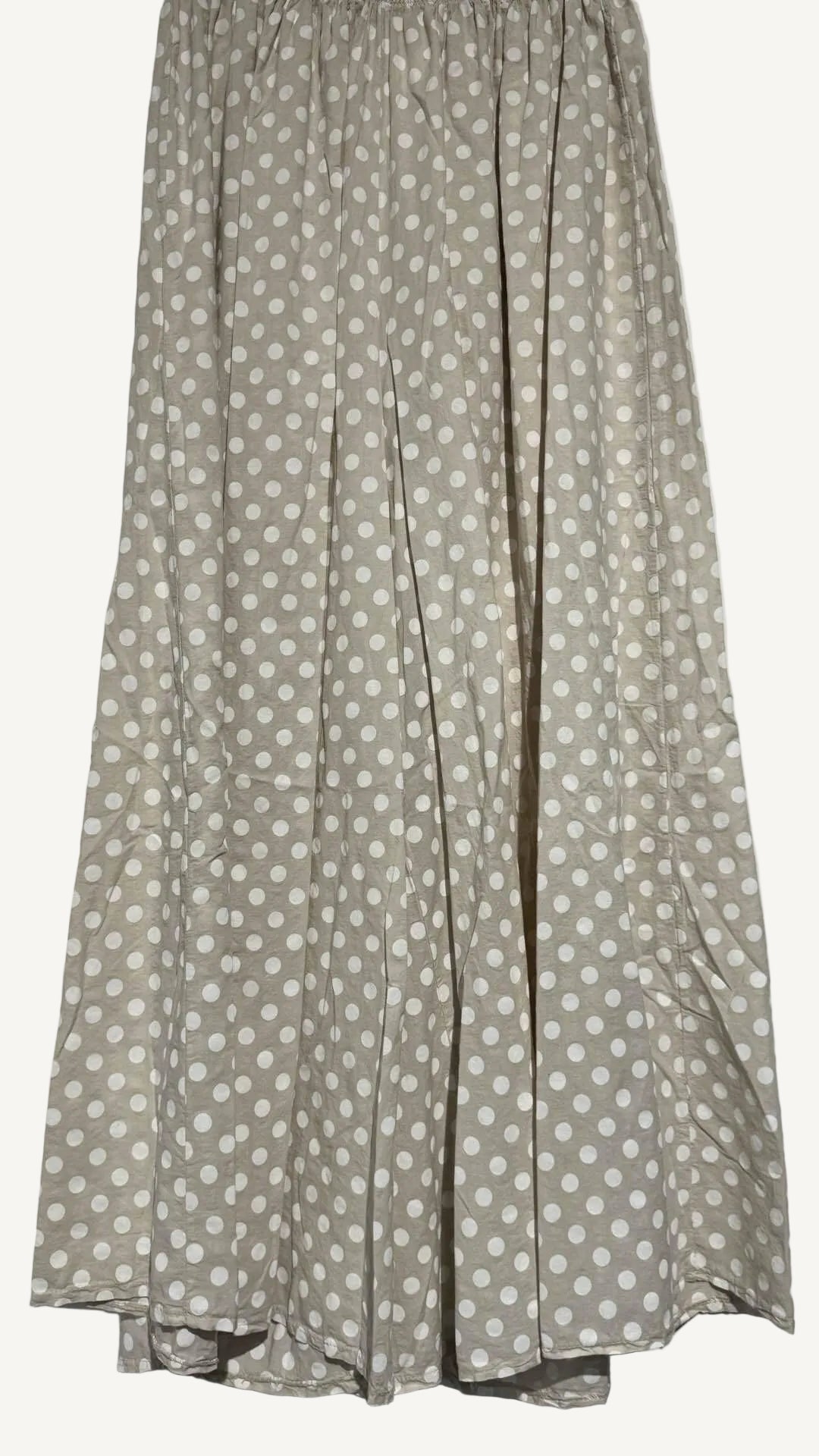 Beige wide leg trousers with white polka dots on a light gray background