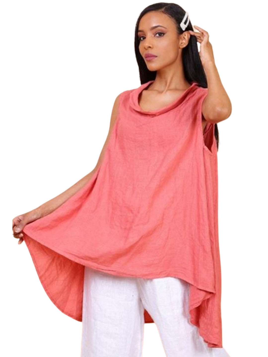 A woman wearing a brick sleeveless cowl neck top with an asymmetrical hem, paired with white trousers.
