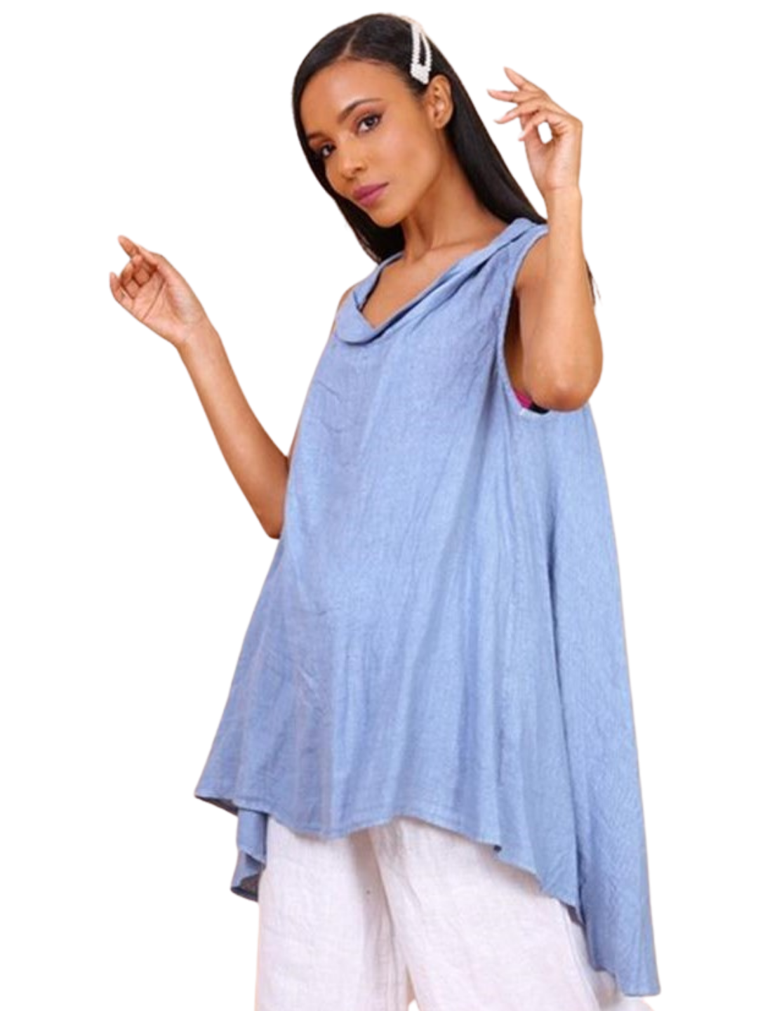 A woman wearing a sky blue sleeveless cowl neck top with an asymmetrical hem, paired with white trousers.